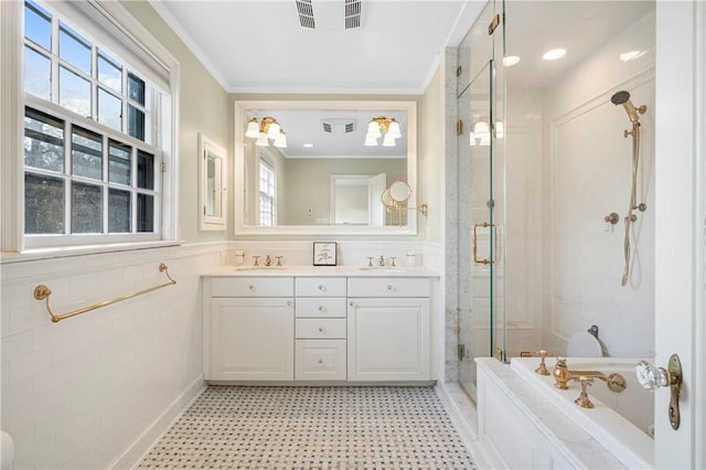 bathroom featuring separate shower and tub, vanity, tile walls, and ornamental molding