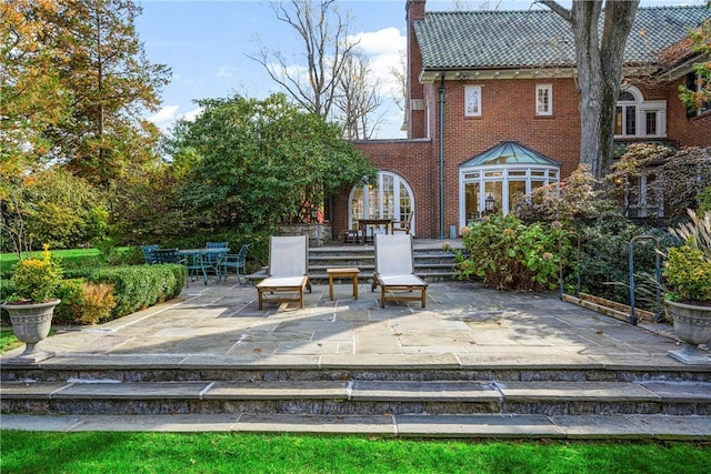 290 Overlook Rd, New Rochelle, NY 10804 - back of house with a patio, a chimney, brick siding, and a tiled roof