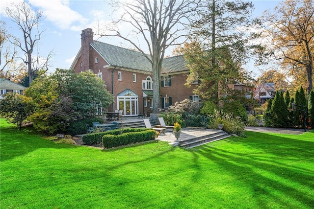 290 Overlook Rd, New Rochelle, NY 10804 - rear view of house with a patio area, a lawn, a chimney, and brick siding