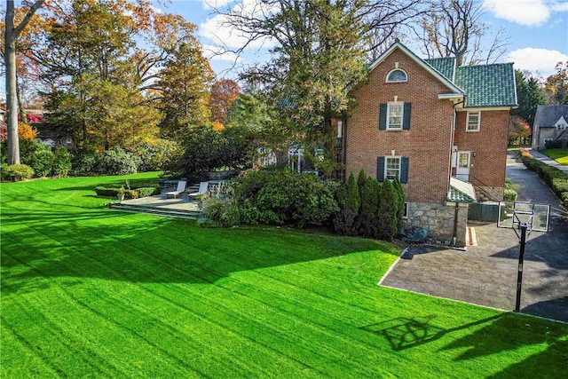 290 Overlook Rd, New Rochelle, NY 10804 - rear view of house with brick siding, a lawn, and a patio area
