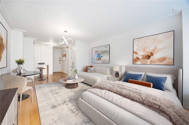 bedroom with crown molding and light wood-type flooring