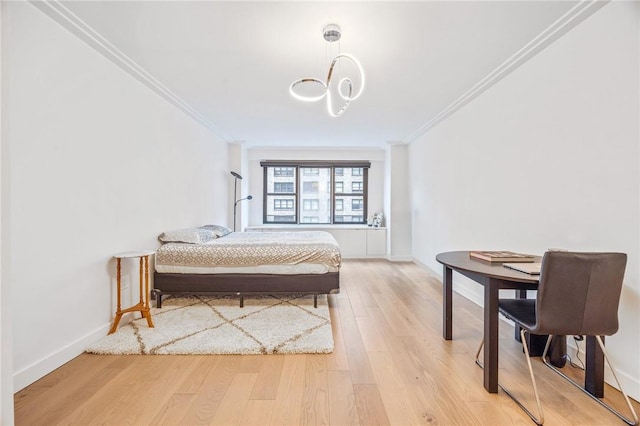 bedroom with light wood-type flooring and crown molding