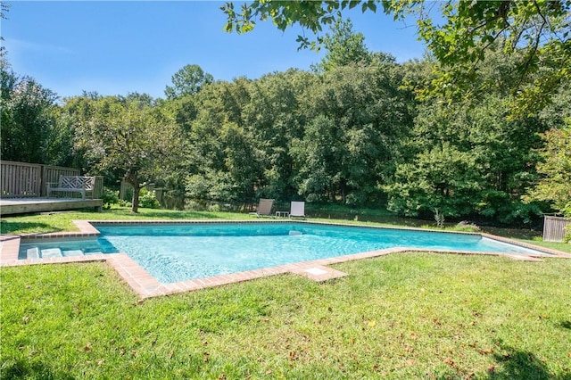 view of pool with a lawn