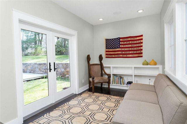 living room with french doors, a healthy amount of sunlight, and hardwood / wood-style flooring