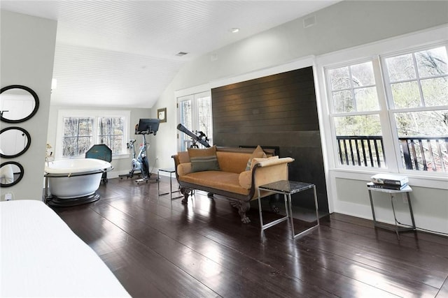 living room featuring dark hardwood / wood-style flooring, plenty of natural light, and vaulted ceiling