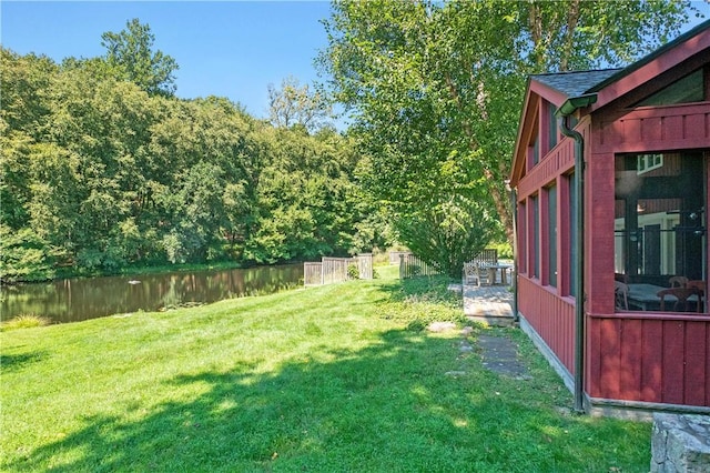 view of yard featuring a water view and a patio area