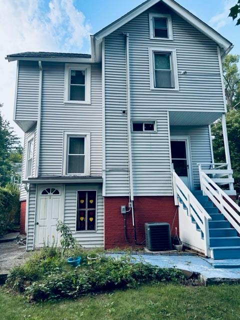 rear view of house featuring central AC