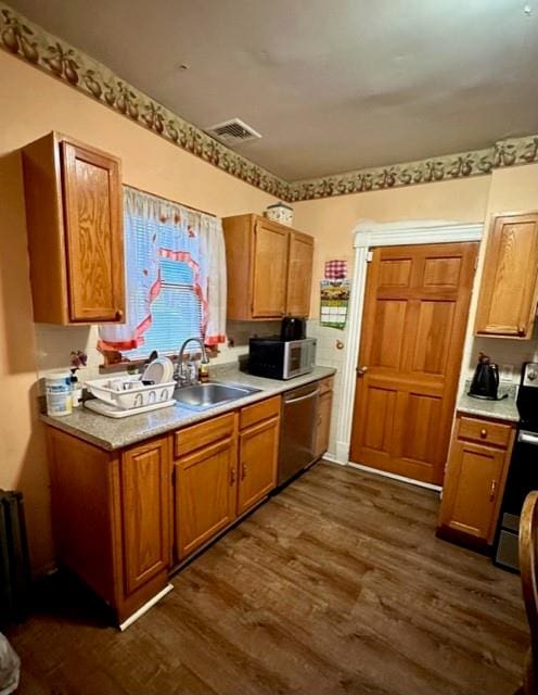 kitchen featuring dark hardwood / wood-style flooring, sink, and appliances with stainless steel finishes