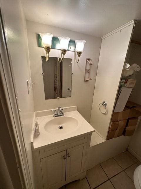 bathroom with tile patterned flooring, vanity, and toilet