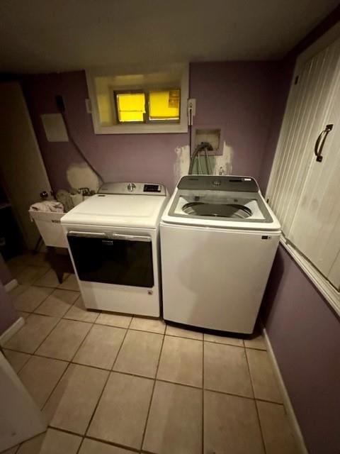 washroom featuring separate washer and dryer and light tile patterned floors