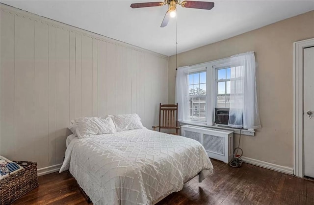 bedroom featuring radiator, ceiling fan, cooling unit, and dark wood-type flooring