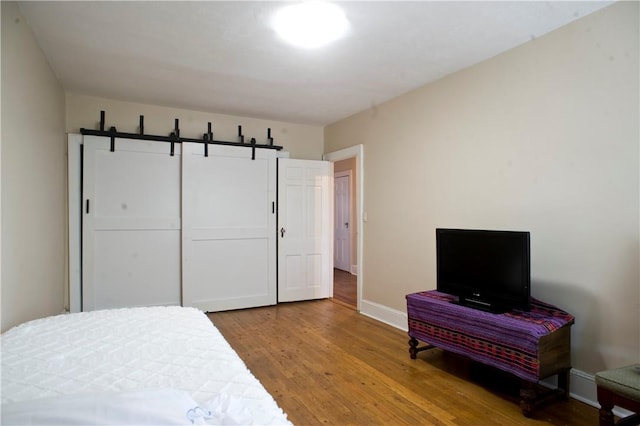 bedroom featuring hardwood / wood-style flooring and a closet