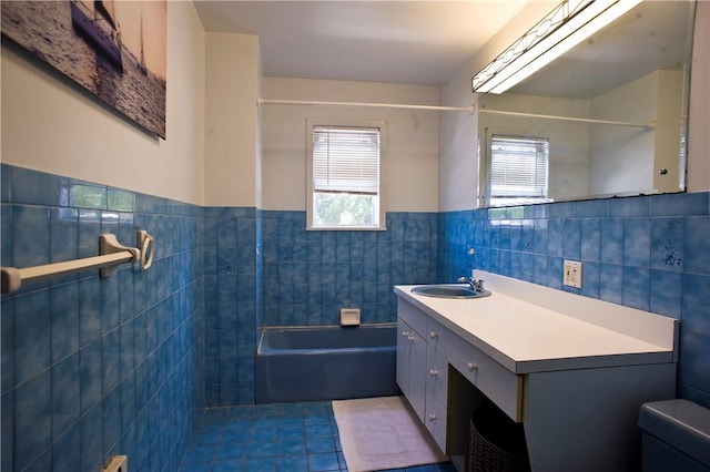 full bathroom featuring shower / bathing tub combination, vanity, tile patterned floors, toilet, and tile walls