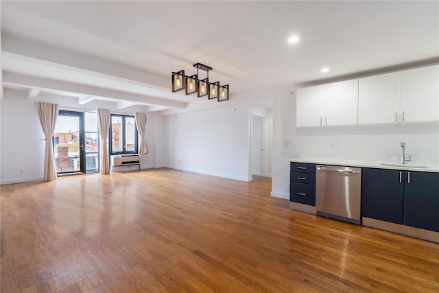 kitchen featuring white cabinetry, dishwasher, sink, hardwood / wood-style flooring, and beam ceiling