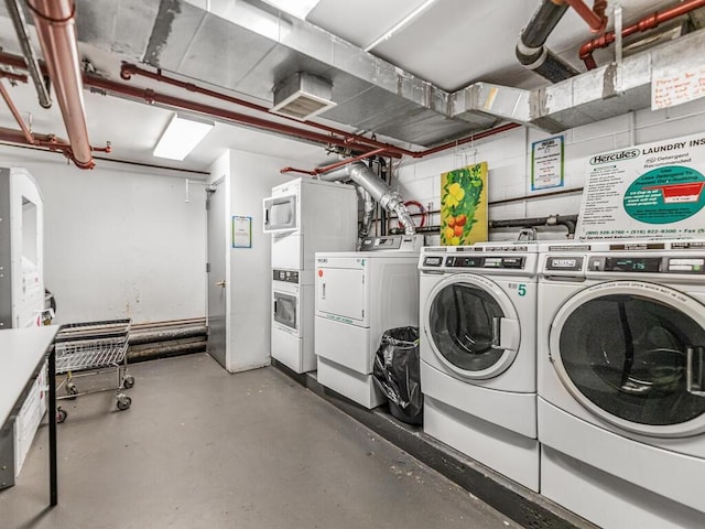 clothes washing area featuring washer and dryer and stacked washing maching and dryer