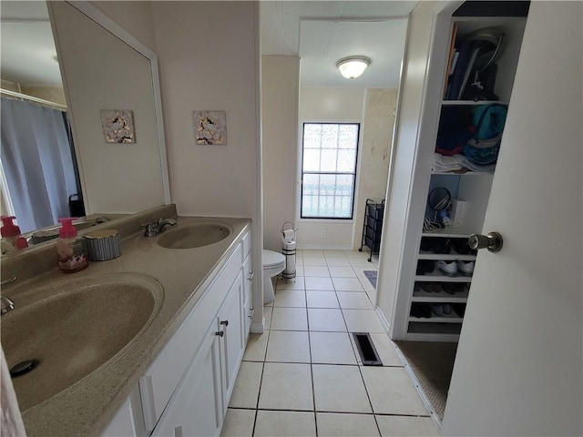 bathroom with tile patterned floors, vanity, and toilet