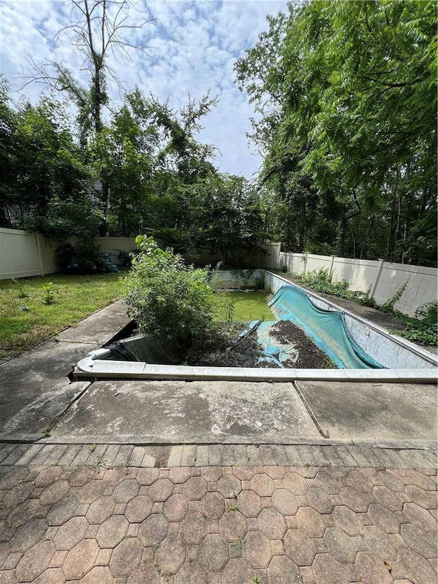 view of pool with a yard