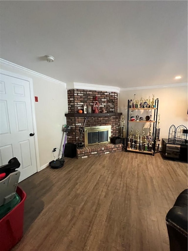 living room featuring hardwood / wood-style floors, crown molding, and a brick fireplace