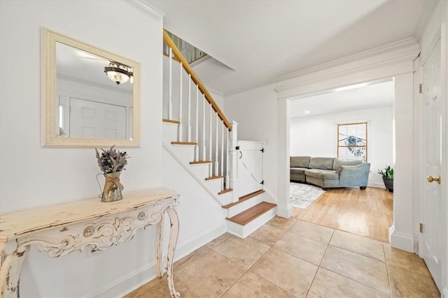 stairway featuring ornamental molding and hardwood / wood-style flooring