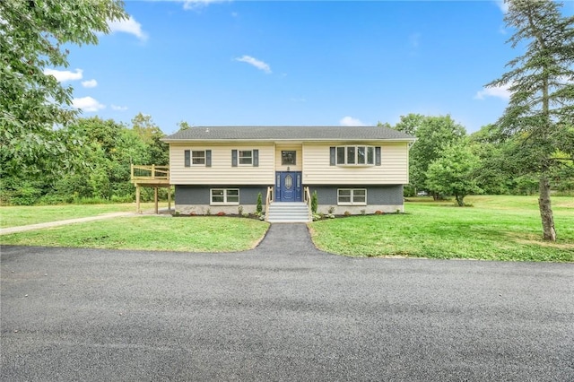 raised ranch with a front lawn