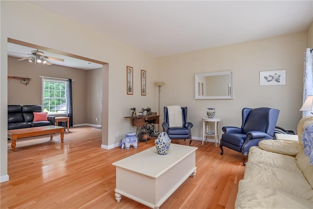 living room with ceiling fan and hardwood / wood-style flooring