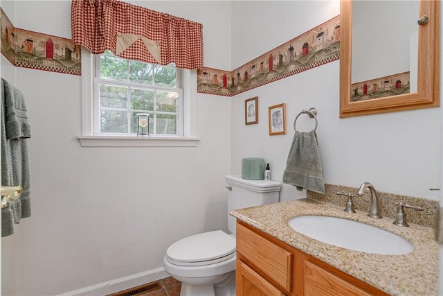 bathroom with tile patterned floors, vanity, and toilet