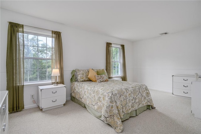 carpeted bedroom with multiple windows