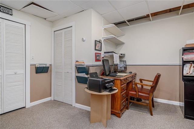 carpeted office featuring a paneled ceiling