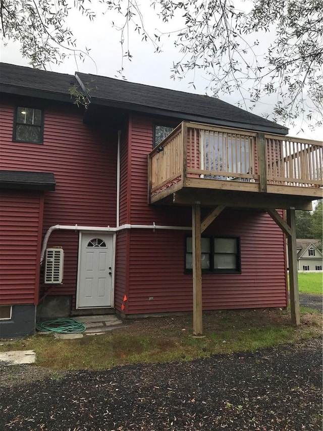 rear view of property featuring a deck