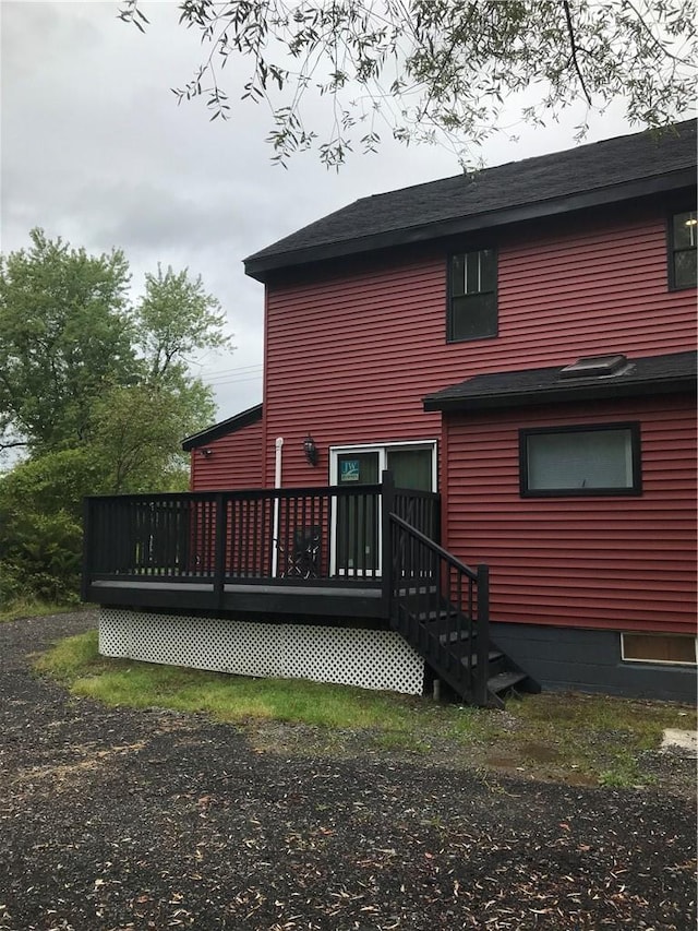 rear view of property featuring a deck