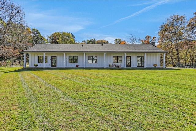 single story home with french doors and a front lawn