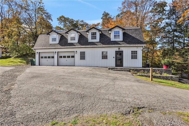 cape cod home featuring a garage