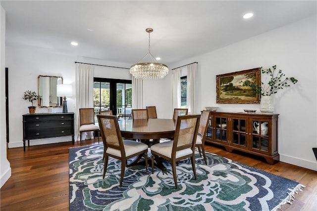 dining area featuring french doors, dark hardwood / wood-style flooring, and a notable chandelier