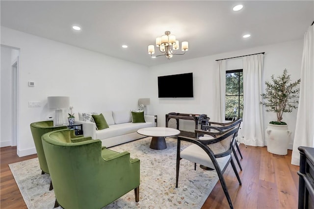 living room featuring hardwood / wood-style flooring and a chandelier