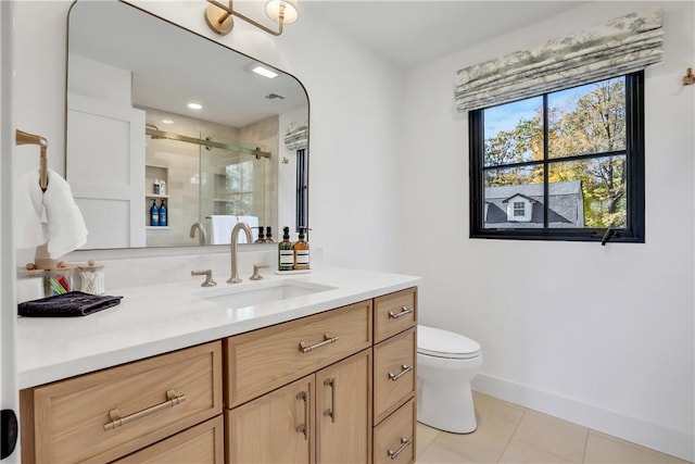 bathroom featuring toilet, vanity, tile patterned floors, and walk in shower