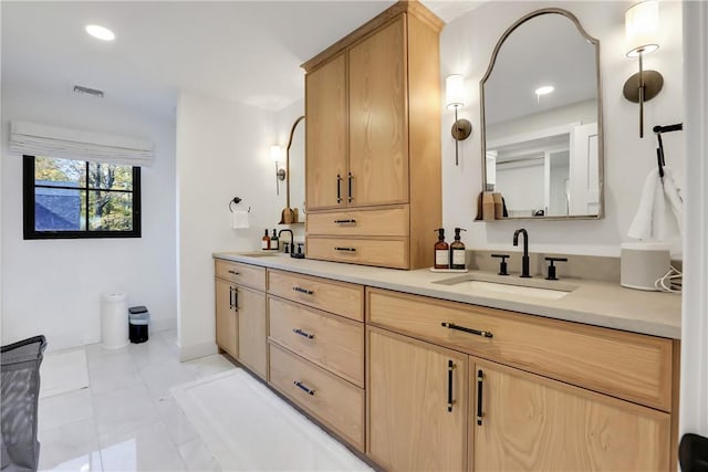 bathroom featuring tile patterned flooring and vanity