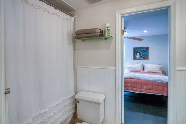 bathroom featuring ceiling fan and toilet