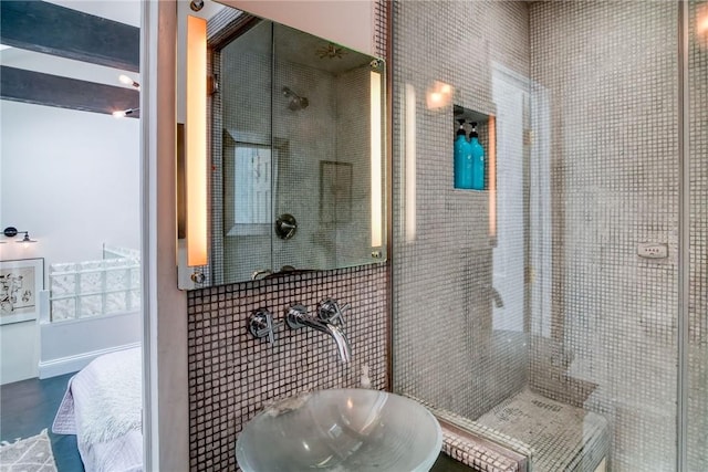 bathroom featuring tile walls, sink, and an enclosed shower