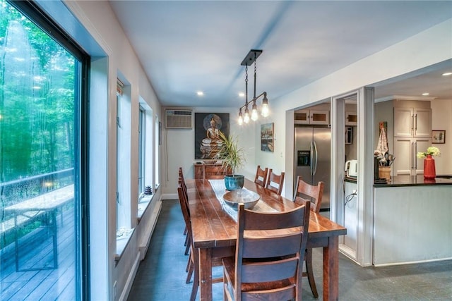 dining space featuring an inviting chandelier and a wall mounted AC