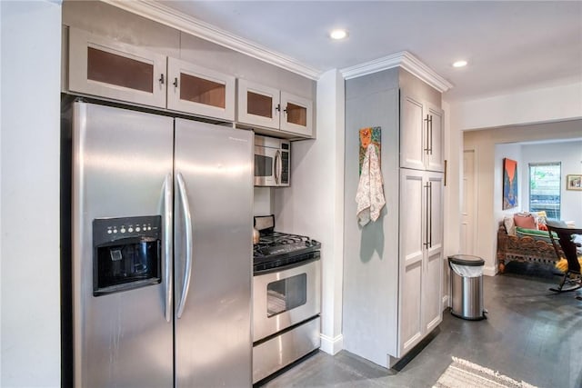 kitchen with white cabinets, ornamental molding, and appliances with stainless steel finishes