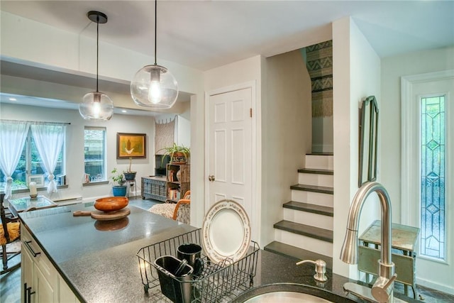 kitchen with white cabinets and hanging light fixtures