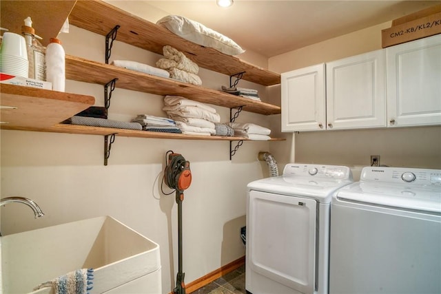 laundry area with cabinets, washer and dryer, and sink