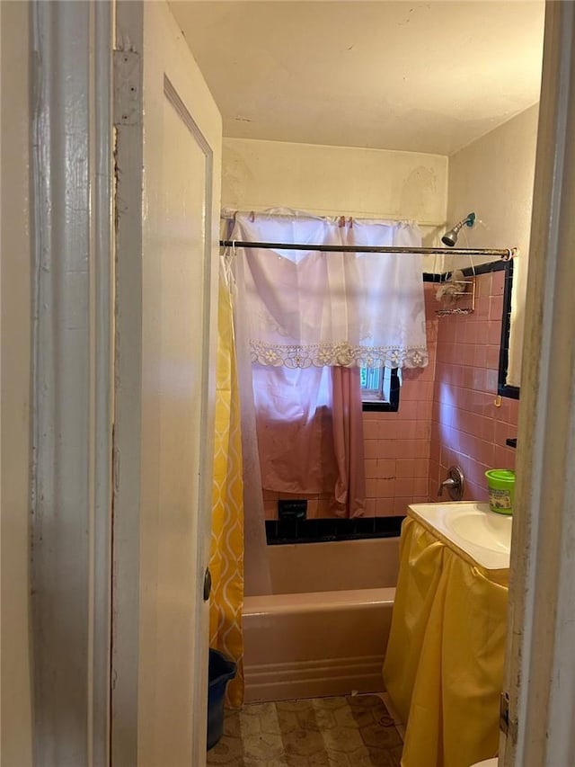 bathroom with shower / tub combo and tile walls