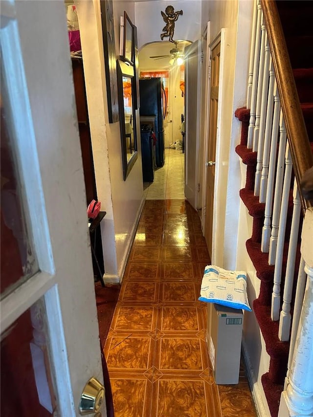 corridor featuring dark tile patterned flooring