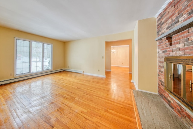 unfurnished living room with light wood-type flooring, a fireplace, baseboards, and baseboard heating