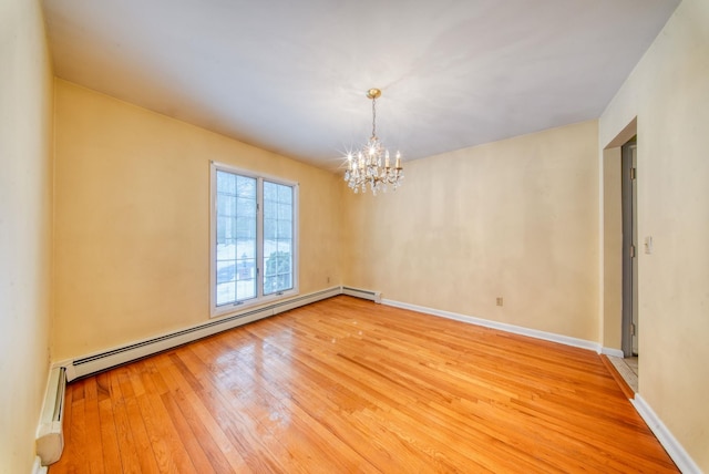 unfurnished room featuring baseboards, baseboard heating, light wood-style flooring, and a notable chandelier