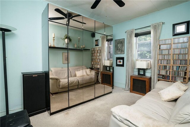 living room featuring light carpet, cooling unit, and ceiling fan