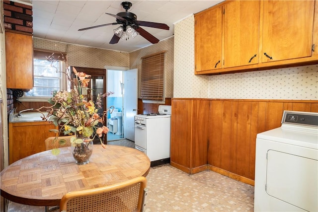 washroom featuring ceiling fan, washer / dryer, and wooden walls