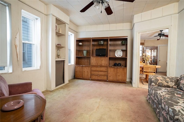 living room featuring ceiling fan and light colored carpet