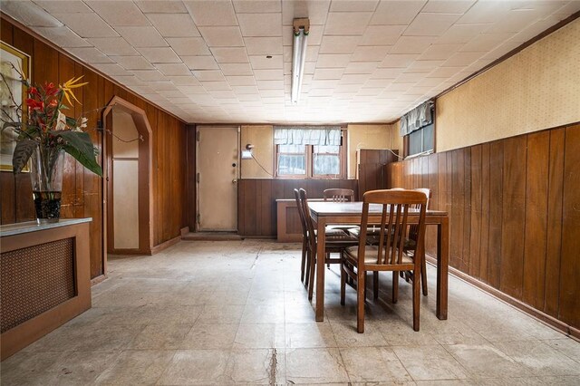 dining room with wood walls